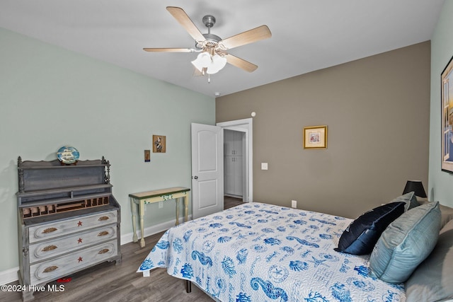 bedroom with ceiling fan and dark hardwood / wood-style floors