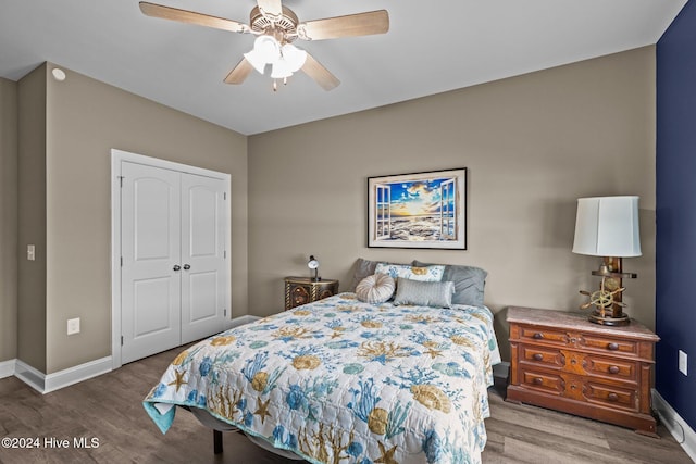 bedroom featuring ceiling fan, wood-type flooring, and a closet