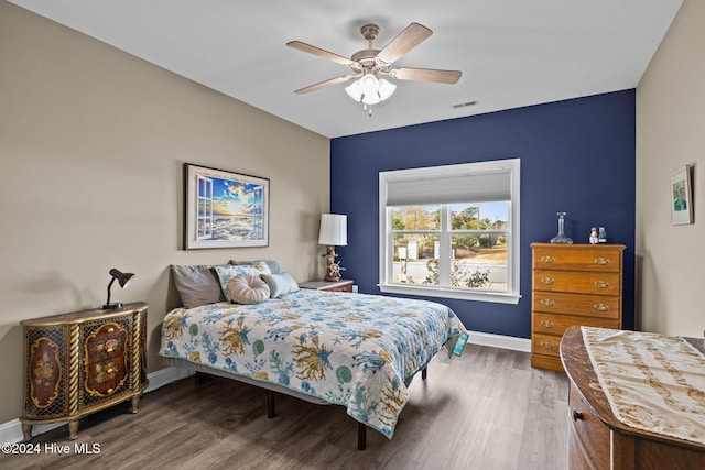 bedroom with ceiling fan and hardwood / wood-style floors