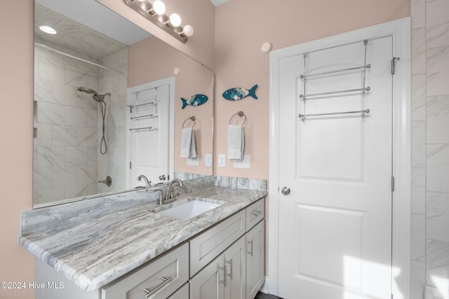 bathroom featuring vanity and tiled shower