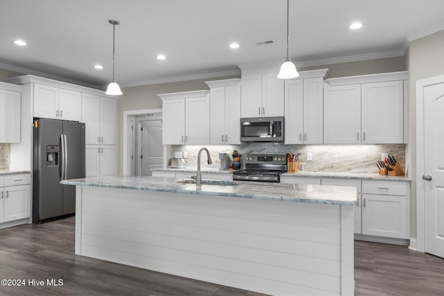 kitchen with a center island with sink, white cabinets, stainless steel appliances, and decorative light fixtures