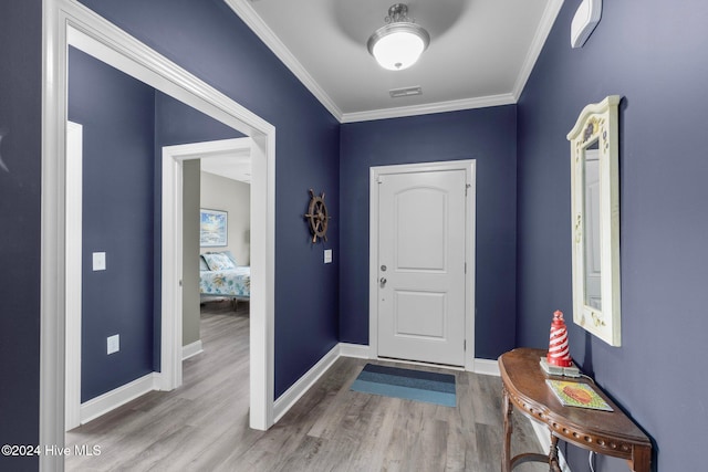 foyer entrance featuring hardwood / wood-style floors and ornamental molding