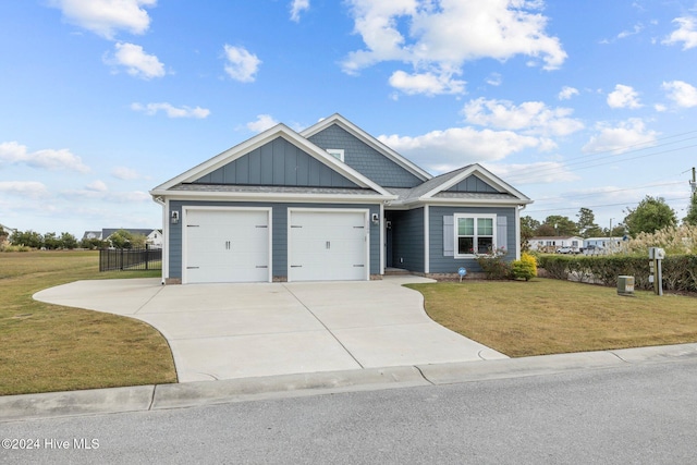 craftsman house with a front lawn and a garage