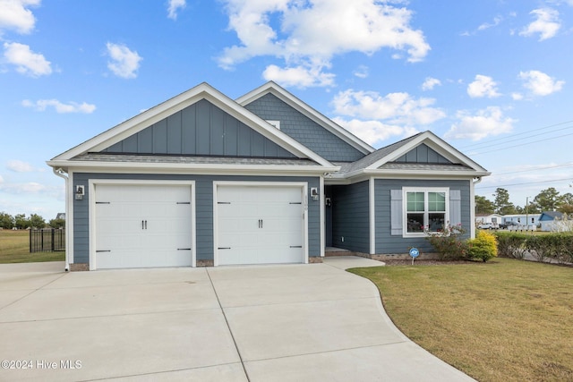 view of front of property featuring a garage and a front lawn