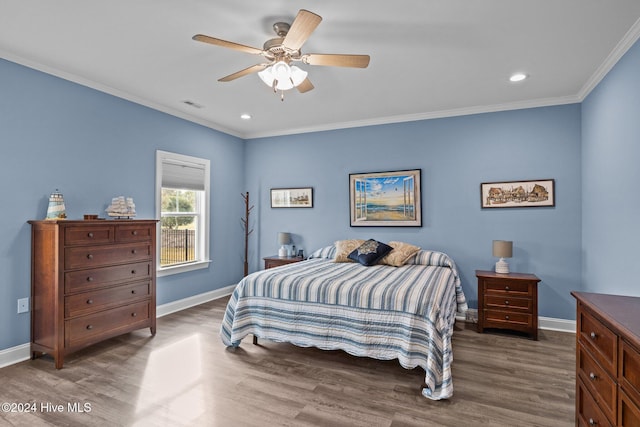 bedroom with crown molding, ceiling fan, and dark wood-type flooring