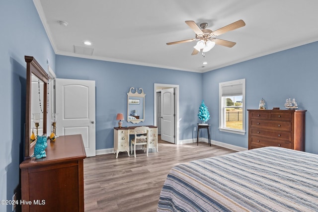 bedroom with hardwood / wood-style floors, ceiling fan, and ornamental molding