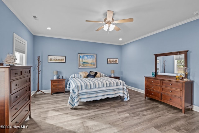 bedroom with light hardwood / wood-style flooring, multiple windows, crown molding, and ceiling fan