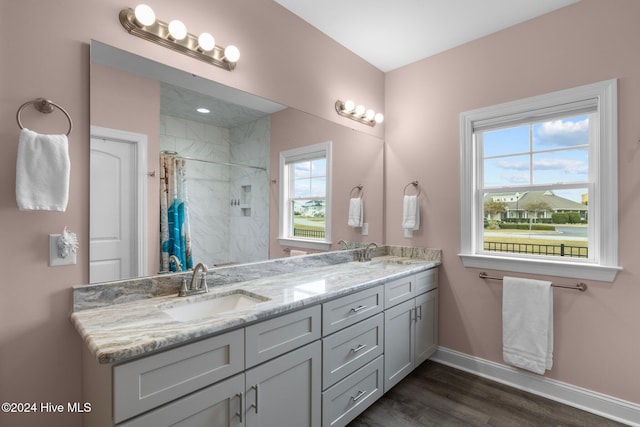 bathroom featuring hardwood / wood-style floors, vanity, and a shower with shower curtain