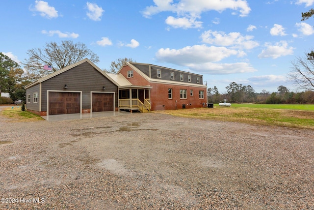 view of front facade with a garage and a sunroom