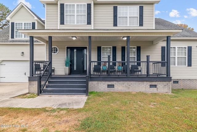 view of front of house with a garage, covered porch, and a front yard