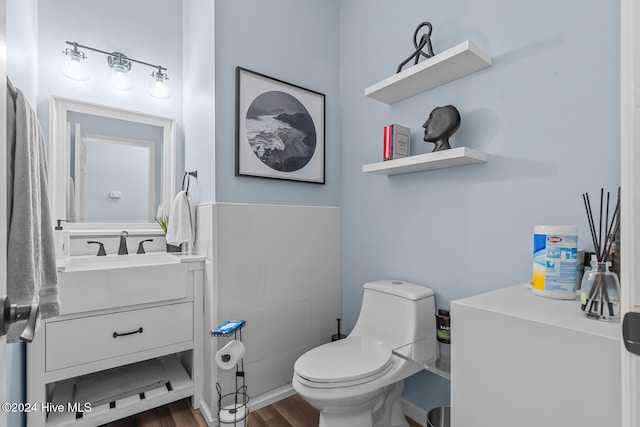 bathroom featuring hardwood / wood-style floors, vanity, and toilet