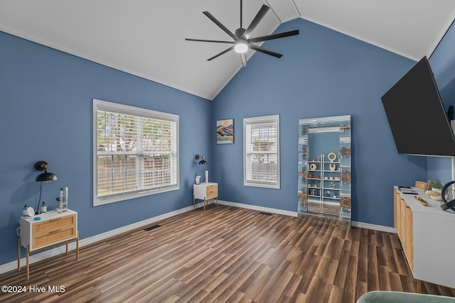 interior space featuring dark hardwood / wood-style flooring, high vaulted ceiling, ceiling fan, and plenty of natural light