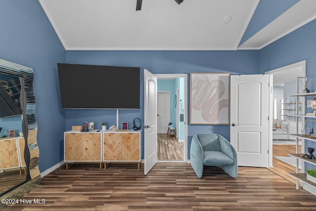 sitting room featuring lofted ceiling, hardwood / wood-style floors, and ornamental molding