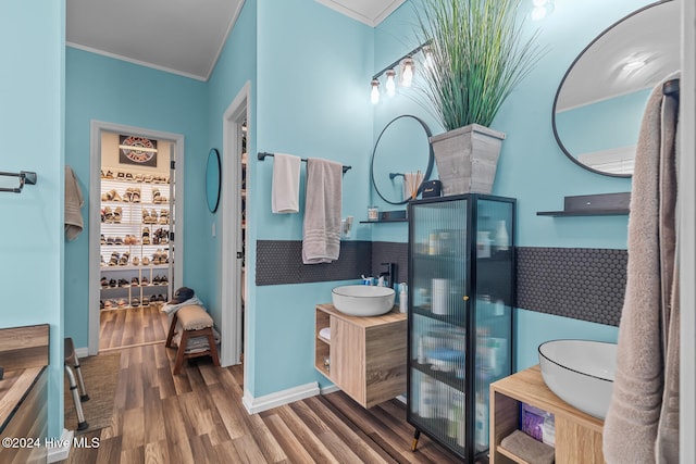 bathroom featuring ornamental molding, hardwood / wood-style floors, and vanity