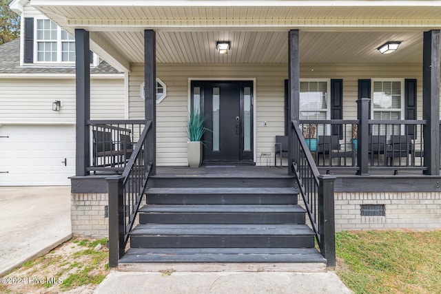 view of exterior entry with a porch