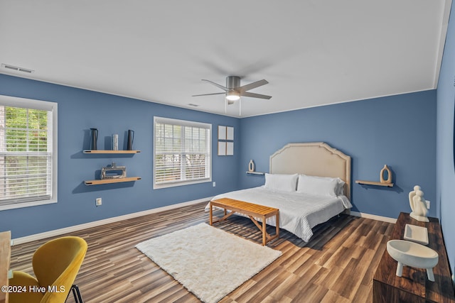 bedroom with dark wood-type flooring and ceiling fan