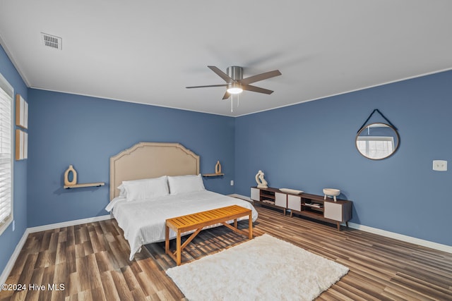 bedroom featuring dark hardwood / wood-style flooring and ceiling fan