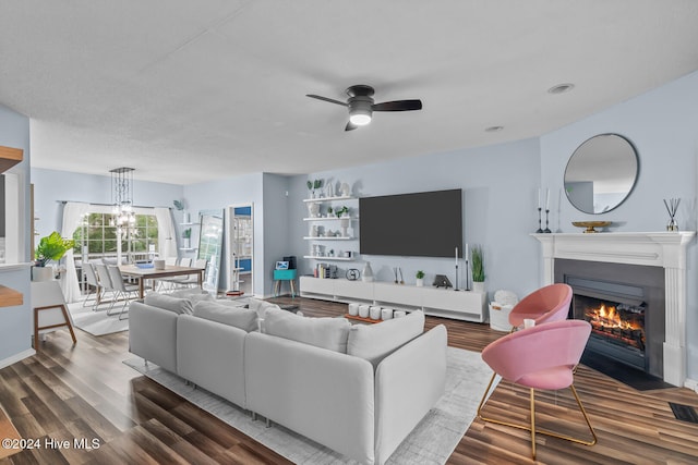 living room with ceiling fan with notable chandelier and wood-type flooring