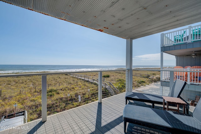 balcony with a beach view and a water view