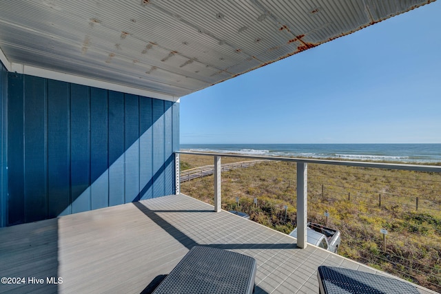 balcony with a water view and a beach view