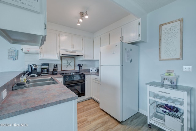 kitchen featuring black electric range, sink, white fridge, and white cabinets