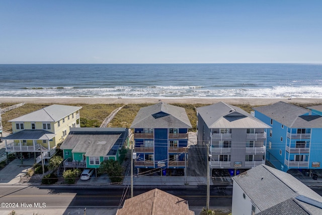 drone / aerial view with a beach view and a water view