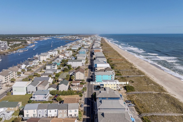 birds eye view of property featuring a beach view and a water view