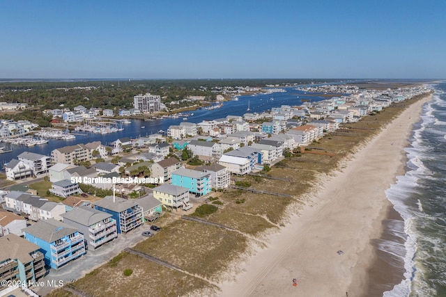 drone / aerial view featuring a water view and a beach view