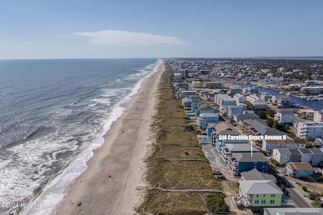 birds eye view of property with a view of the beach and a water view