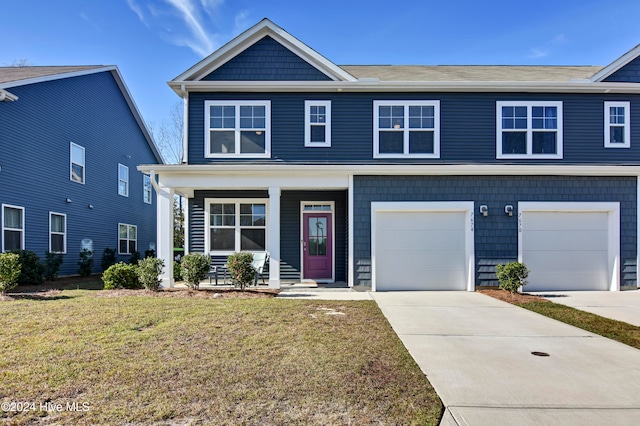 view of front of home featuring a garage and a front lawn