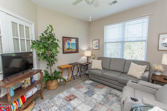 living room with light hardwood / wood-style flooring and ceiling fan