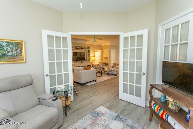 living area featuring ceiling fan, light hardwood / wood-style flooring, and french doors