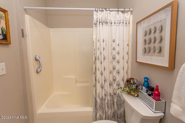 bathroom with toilet and shower / bathtub combination with curtain