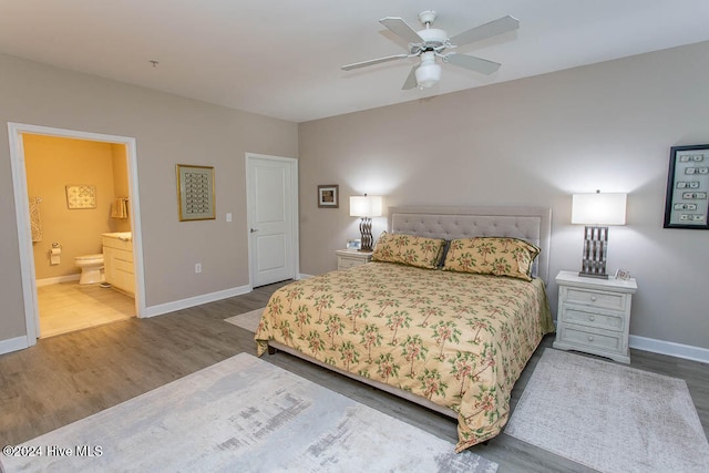 bedroom featuring hardwood / wood-style floors, ceiling fan, and ensuite bath