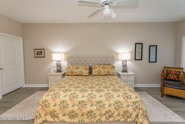 bedroom with ceiling fan and dark hardwood / wood-style flooring