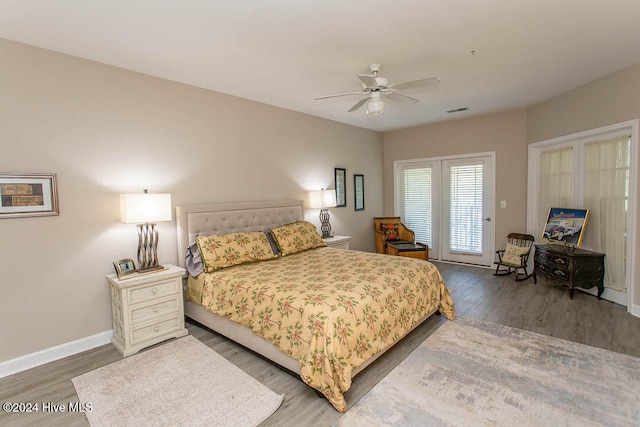 bedroom with dark hardwood / wood-style flooring, ceiling fan, and access to exterior