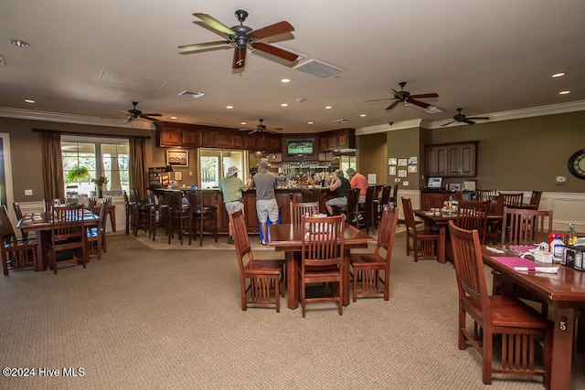 dining space featuring light colored carpet and ornamental molding