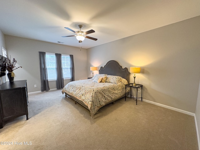 bedroom featuring ceiling fan and light colored carpet