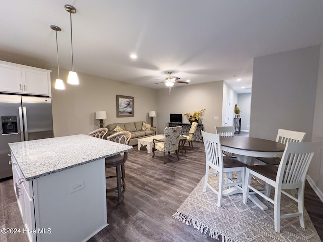 kitchen featuring ceiling fan, dark hardwood / wood-style floors, stainless steel refrigerator with ice dispenser, decorative light fixtures, and white cabinets