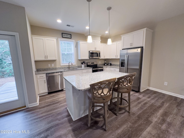 kitchen with white cabinets, appliances with stainless steel finishes, and a kitchen island