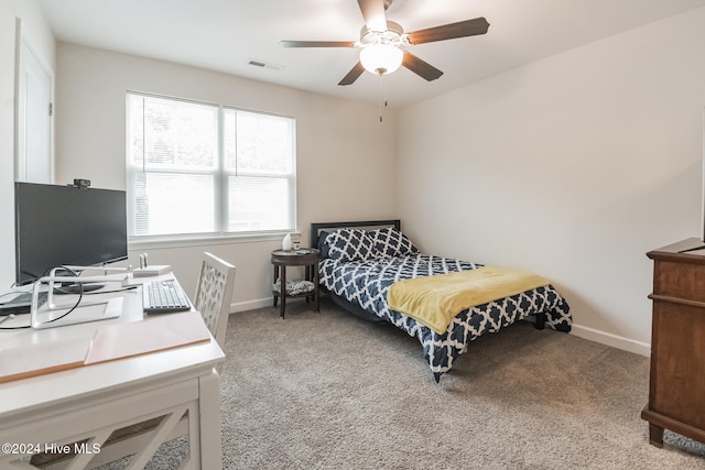 bedroom featuring light colored carpet and ceiling fan