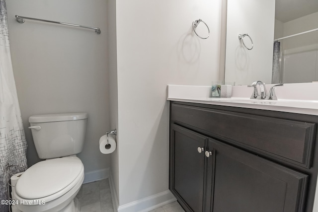 bathroom featuring tile patterned flooring, vanity, and toilet