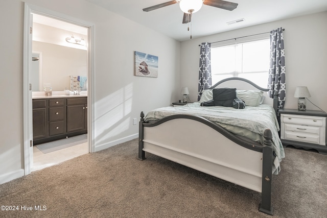 carpeted bedroom featuring connected bathroom and ceiling fan