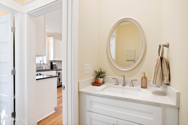 bathroom with vanity and wood-type flooring