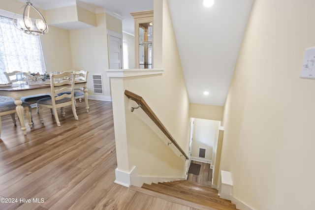 304 Birmingham Ave Unit 2, Carolina Beach, NC 28428 - stairs featuring wood finished floors, a chandelier, baseboards, and ornamental molding