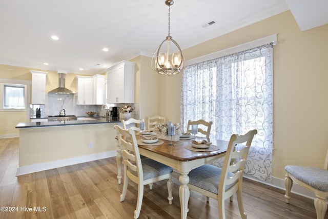 304 Birmingham Ave Unit 2, Carolina Beach, NC 28428 - dining room featuring a chandelier, light wood finished floors, ornamental molding, recessed lighting, and baseboards