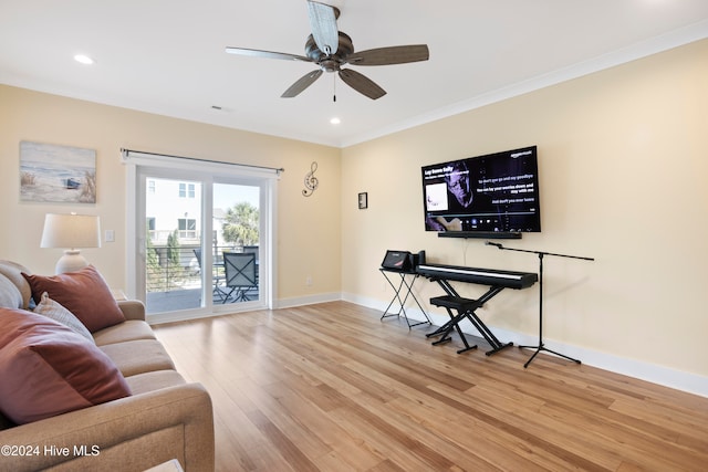 living room featuring ceiling fan, crown molding, and light hardwood / wood-style flooring