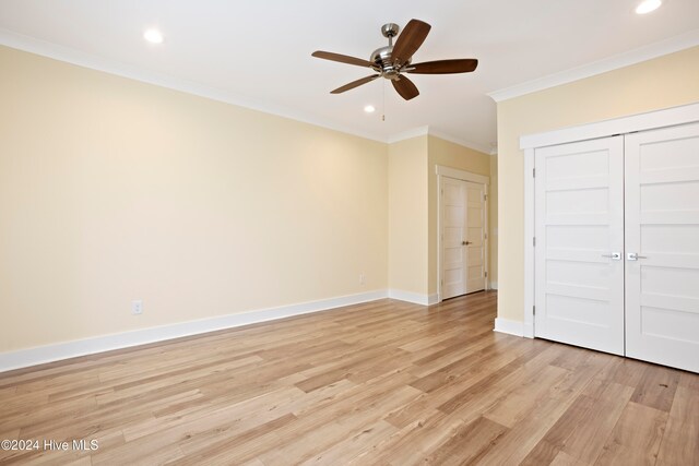 unfurnished bedroom with crown molding, a closet, ceiling fan, and light wood-type flooring