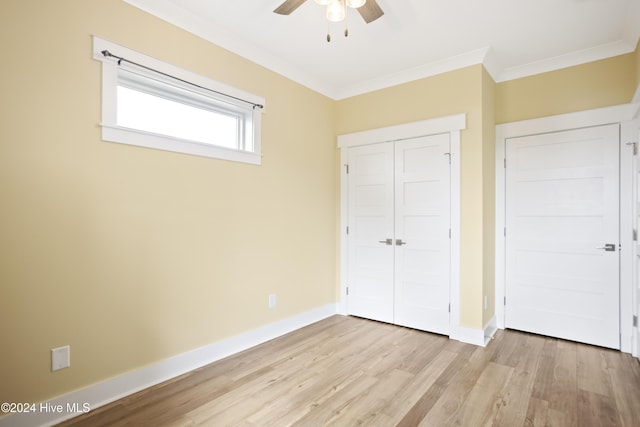 304 Birmingham Ave Unit 2, Carolina Beach, NC 28428 - unfurnished bedroom with ornamental molding, light wood-style flooring, a closet, and baseboards