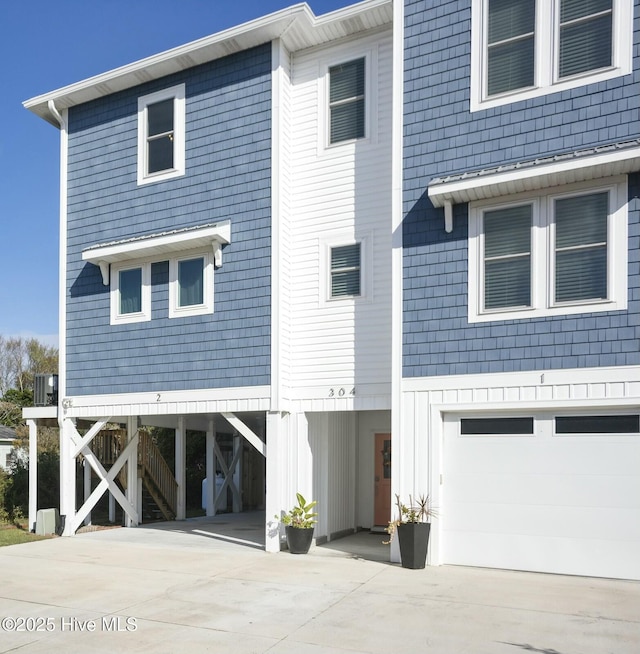 304 Birmingham Ave Unit 2, Carolina Beach, NC 28428 - view of front of house with a garage, driveway, and a carport
